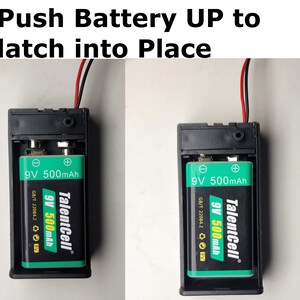 May include: Close-up of a black battery holder with a 9V battery inserted. The battery is green and black with the text "TalentCell 9V 500mAh" printed on it. The image shows the battery being pushed up into the holder to latch into place.