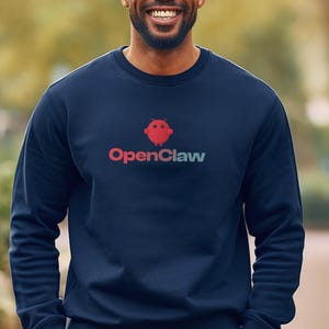 May include: Navy blue sweatshirt with the text "OpenClaw" in red and green. The sweatshirt has a crew neck and long sleeves. The image shows a person wearing the sweatshirt.