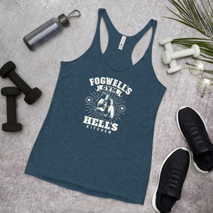 May include: A blue tank top with a white graphic design that says "Fogwell's Gym Hell's Kitchen" with a pair of boxing gloves in the center.