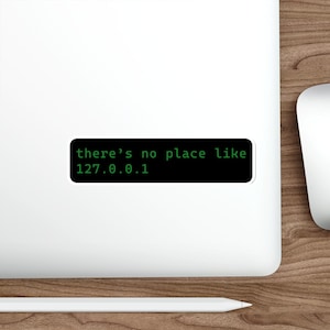 May include: A white ceramic mug with a black handle and the text "But First, Coffee" in a handwritten style. The mug is on a white surface. The mug is 10 cm tall.