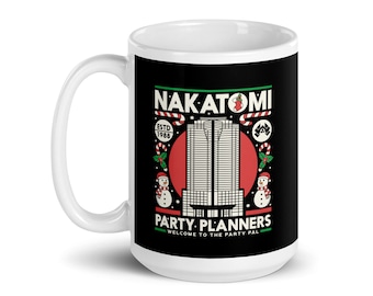May include: White ceramic mug with a black background featuring the text "NAKATOMI PARTY PLANNERS" and a graphic of a building. The design includes candy canes, holly, and snowmen, with "ESTD 1988" text.