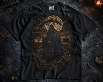 May include: A black short-sleeved t-shirt featuring a graphic print of a hooded figure holding a scythe under a full moon. The design includes a field, a silhouette of a house, and the text "DEATH REAPS WHAT YOU SOW" in a dark, weathered style.