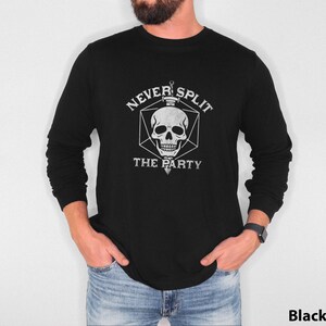 May include: Black long-sleeve shirt with a white graphic of a skull inside a geometric shape, with the text "NEVER SPLIT THE PARTY". The shirt is made of a soft material.