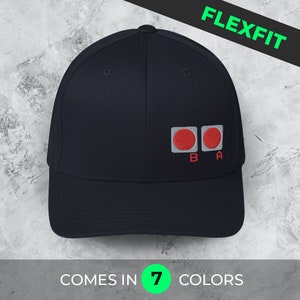 May include: A navy blue baseball cap with a red and white logo featuring two red circles with the letters "B" and "A" underneath. The cap is labeled "Flexfit" and "Comes in 7 colors".