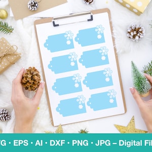 May include: Set of eight blue gift tags with snowflake designs. The tags are printed on white paper and are ready to be used for gift wrapping.