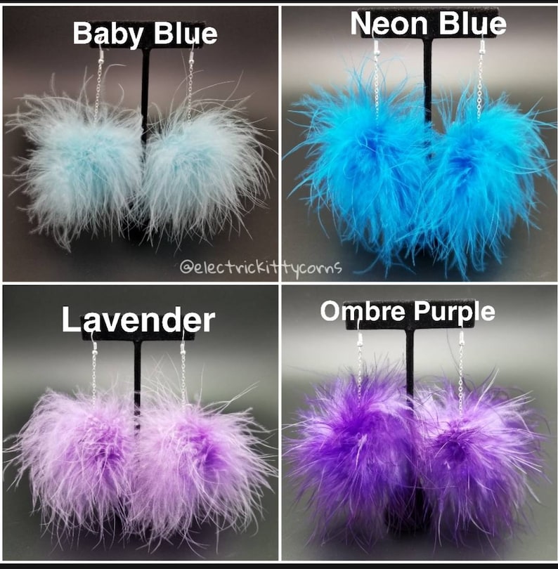 May include: Four pairs of feather earrings displayed on a black stand. The earrings are in four colors: baby blue, neon blue, lavender, and ombre purple.