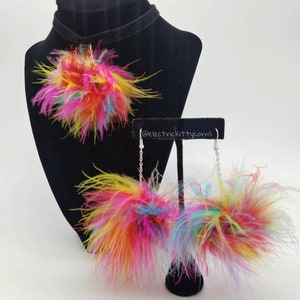 May include: A colorful feather choker necklace and matching earrings. The necklace and earrings feature a pom-pom style with multi-colored feathers.