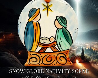 May include: A round ceramic ornament shaped like a snow globe featuring a painted nativity scene with two figures in blue and green robes standing over a manger. A yellow star shines above them. The base is orange with black swirl patterns.