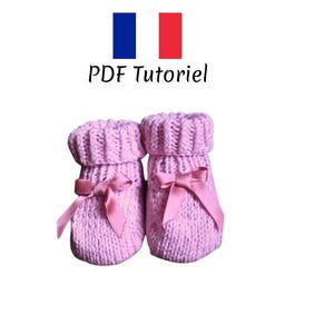 May include: A pair of pink knitted baby booties with a pink satin bow on each. PDF Tutorial.