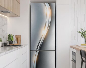 May include: A refrigerator with a decorative wrap featuring a silver and gray abstract design. The design includes curved lines with a gradient effect and a bright yellow-orange glow. The refrigerator is in a modern kitchen setting.