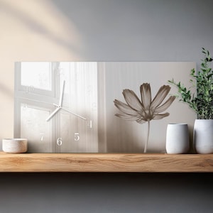May include: A rectangular wall clock with a floral design and a window-like background. The clock face features white numerals and hands. The image includes a sepia-toned flower and decorative vases on a wooden shelf.