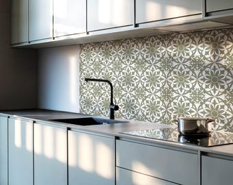 May include: A modern kitchen with white cabinets and a black faucet. The backsplash is a green and white patterned tile.