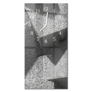 May include: A rectangular wall clock with a modern design. The clock face has a grey, textured background with white numerals and hands. The design incorporates geometric shapes and shadows, creating a contemporary aesthetic.