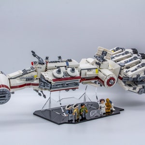 May include: A white and red Lego Star Wars ship with four engines and a display stand. Four Lego minifigures are in front of the ship.