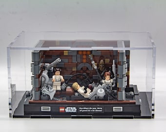 May include: A clear acrylic display case with a Star Wars Lego set inside. The set features a scene from the movie with characters like Princess Leia, Han Solo, and Chewbacca. The text on the base reads "One thing's for sure. We're all gonna be a lot thinner!"