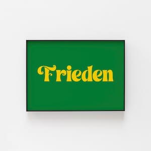 May include: A framed print with a green background and the word "Frieden" in yellow lettering.