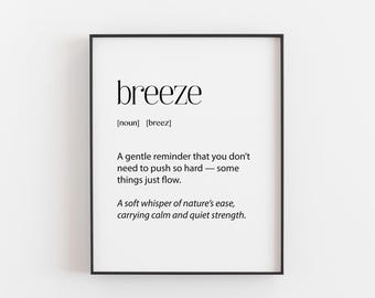 May include: A framed print featuring the word "breeze" in a minimalist font. The print includes a definition and a quote about ease and strength. The frame is black, and the background is white.