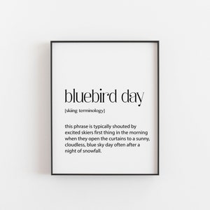 May include: A black and white printable wall art print with the definition of "bluebird day" in skiing terminology. The definition reads: "This phrase is typically shouted by excited skiers first thing in the morning when they open the curtains to a sunny, cloudless, blue sky day often after a night of snowfall."