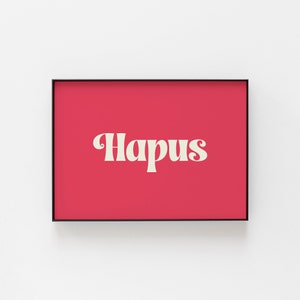 May include: A framed print with a red background and the word "Hapus" in a white, retro font.