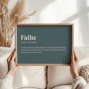 May include: A framed print with a teal background and white text. The text reads "Fàilte [noun] [Scottish] A word used to greet people in Scotland, reminding us that no matter where you are, a warm welcome is always just a word away."