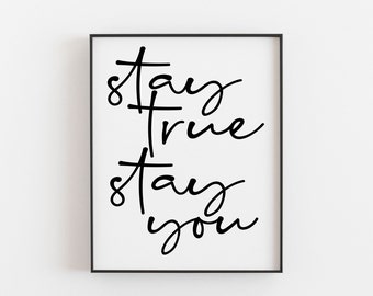 May include: Black and white typography print with the text "stay true stay you" in a modern calligraphy style.