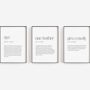May include: Three black framed prints with white text on a white background. The prints are definitions of Scottish slang words: "aye", "nae bother", and "gies a swally".