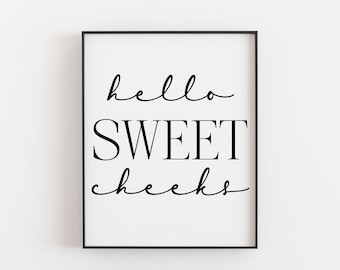 May include: Black and white framed print with the text "hello sweet cheeks" in a cursive font.