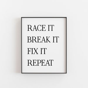 May include: Black and white motivational quote print in a black frame. The quote reads "Race it, Break it, Fix it, Repeat."
