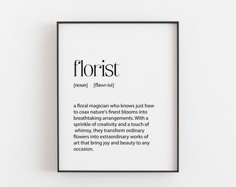 May include: A framed print with the word "florist" in a stylish font. The definition below describes a floral magician who creates breathtaking arrangements. The print is in a black frame and is suitable for home or office decor.