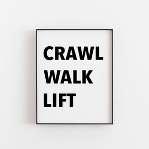 May include: Black and white framed print with the words "CRAWL WALK LIFT" in bold, uppercase letters.