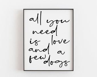 Puede incluir: Impresión enmarcada en blanco y negro con el texto "all you need is love and a few dogs".