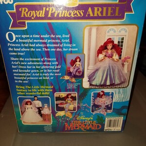 May include: A box for a Royal Princess Ariel doll from Disney's The Little Mermaid. The box features a picture of Ariel in a purple gown with a gold crown. The text on the box reads "Royal Princess Ariel" and "Disney's The Little Mermaid".