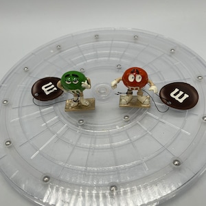 Monet M&M Candy Green Girl and Red Pretzel Trinket Boxes. Sold Separately.