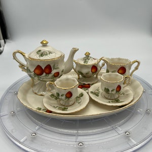 Gorgeous Porcelain Miniature Strawberry And Vines Tea Set with Gold Embellishments.