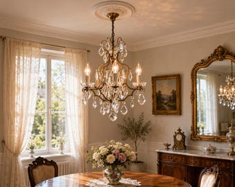 May include: A multi-armed brass chandelier featuring numerous clear, faceted crystal teardrop pendants and candle-style light bulbs. The fixture is suspended from a decorative ceiling medallion and showcases a metallic finish with intricate metal scrollwork.