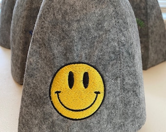 May include: Gray felt hat with a yellow smiley face embroidered on the front.