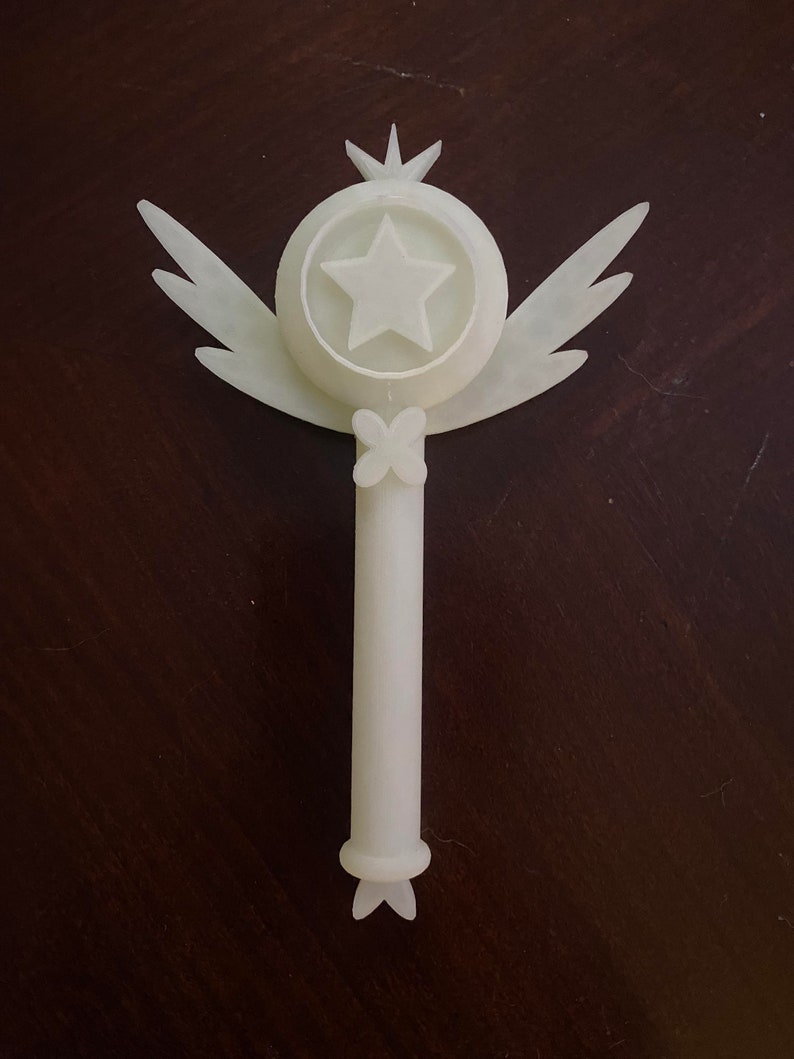 May include: White plastic wand with a star and wings at the top and a butterfly design at the bottom.