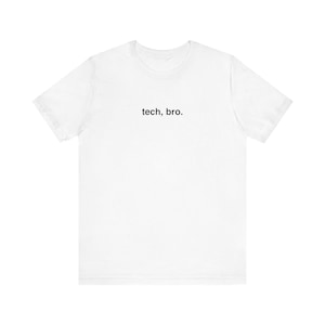 May include: A white short-sleeved t-shirt featuring the text "tech, bro." printed in a simple, black, sans-serif font centered on the upper chest area. The garment has a classic crew neckline and a standard fit with short sleeves and a straight hem.