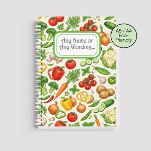 May include: A spiral-bound notebook with a vibrant vegetable design. The cover displays illustrations of tomatoes, broccoli, peppers, onions, and other produce. Text on the cover reads "Any Name or Any Wording..." and "A5 / A4 Eco-Friendly".