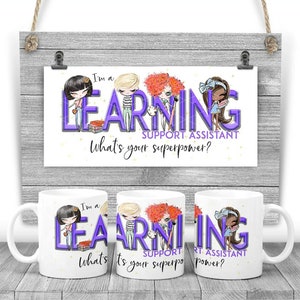 May include: White ceramic mugs with the text "I'm a Learning Support Assistant, What's your superpower?" in purple and black. The mugs feature cartoon illustrations of children. A matching poster hangs in the background.