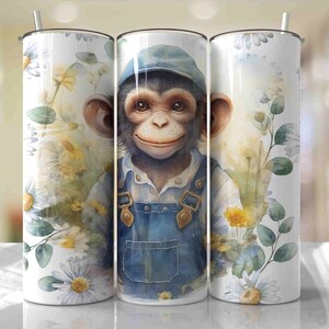 May include: A stainless steel tumbler with a white background and a watercolor illustration of a chimpanzee wearing a blue hat and overalls. The chimpanzee is surrounded by white daisies and green leaves.