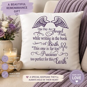 May include: A white square pillow with purple text and angel wing graphics. The text reads "One Day An Angel Said...too perfect for this Earth." The pillow is 40cm x 40cm and machine washable. A beautiful remembrance gift.