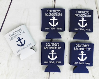 May include: Six blue and white can coolers with the text "Courtney's Bachelorette" and an anchor symbol. The text "Lake Travis, Texas" is also printed on each cooler.
