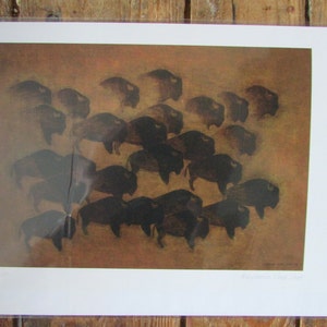 May include: A vintage print of a herd of bison in a brown and tan landscape. The bison are dark brown and black and are depicted in a stylized, almost abstract way. The print is titled "American Bison Herd".