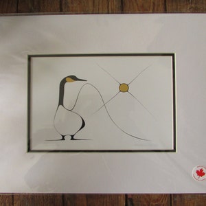 May include: A black and white stylized illustration of a goose with a yellow beak and a yellow sun in the background. The goose is standing on a white surface and the sun is surrounded by black lines.