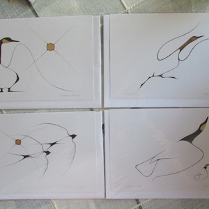May include: Set of four black and white line drawings of birds on white card stock. The drawings are in a minimalist style and feature birds in flight and at rest. The birds are outlined in black ink and have a few details in gold ink.