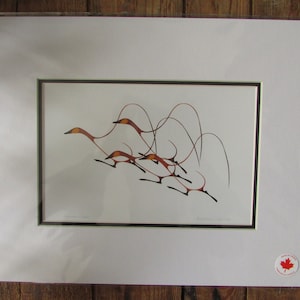 May include: A framed print of a stylized artwork depicting a group of birds in flight. The birds are rendered in shades of orange, brown, and black against a white background. The artwork is framed in a black and green mat.