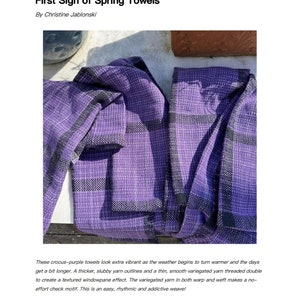 May include: Two purple and black woven towels with a windowpane pattern. The text "First Sign of Spring Towels" is at the bottom of the image.