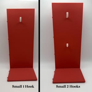 May include: Two red display stands with white hooks. The stand on the left has one hook and the stand on the right has two hooks. The text "Small 1 Hook" and "Small 2 Hooks" are at the bottom of each stand.