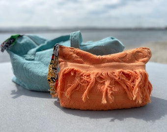 Orange terry cloth toiletry bag with colorful African lining